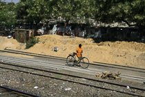 [ photo: On the Way to Ajmer, Boy in Orange Shirt Walking Bike, Rajasthan, India, February 2010 (img 182-086) ]